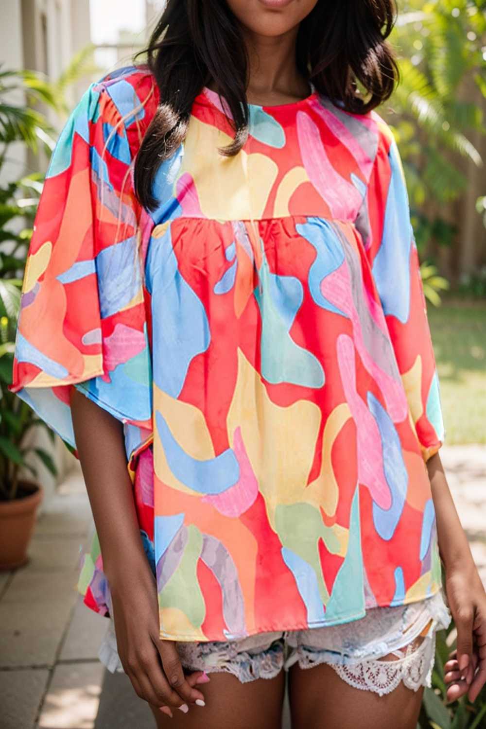 vibrant abstract print flowy sleeve round neck top